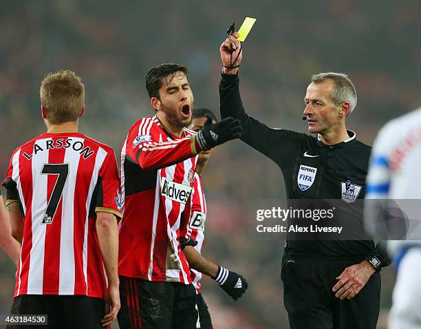 Referee Martin Atkinson shows Ricardo Álvarez of Sunderland during the Barclays Premier League match between Sunderland and Queens Park Rangers at...