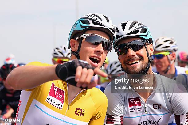 Race leader Niki Terpstra of The Netherlands and Etixx - Quick-Step chats to team mate Tom Boonen of Belgium at the start of stage four of the 2015...