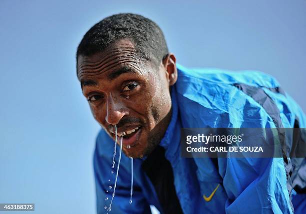 Ethiopia's long distance and marathon runner Kenenisa Bekele takes a break at his training grounds in Sululta near Addis Ababa on January 16, 2014....