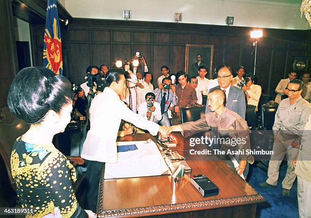 Former Japanese Imperial Army intelligent officer Hiroo Onoda shakes hands with Philippine President Ferdinand Marcos as Onoda finally surrendered on...