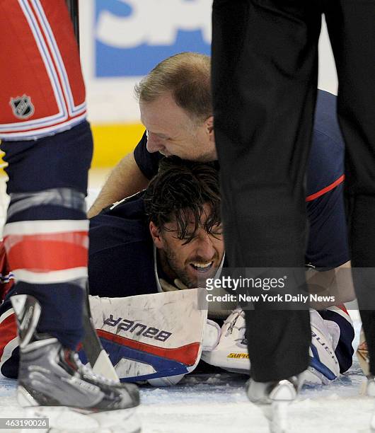 New York Rangers goalie Henrik Lundqvist gets tended to after having stick hitting him under the neck during the second period when the New York...