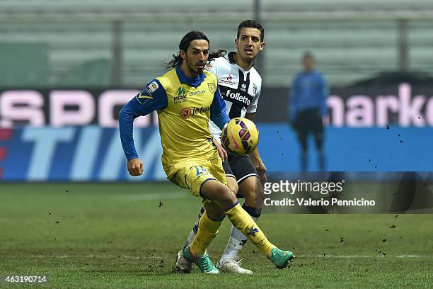 Zouhair Feddal of Parma FC competes with Ezequiel Schelotto of AC Chievo Verona during the Serie A match between Parma FC and AC Chievo Verona at...