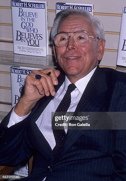 Reverend Robert H. Schuller autographs copies of his book "Believe in the God Who Believes in You" on October 2, 1989 at B. Dalton Bookseller, 666...