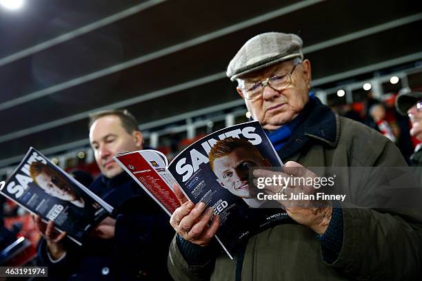 Fans read the matchday programme before the Barclays Premier League match between Southampton and West Ham United at St Mary's Stadium on February...