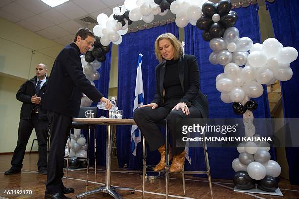 Israeli Labour Party leader Isaac Herzog and former justice minister and Hatnuah party leader Tzipi Livni attend an election campaign meeting in...