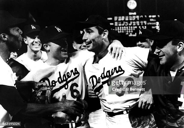 Pitcher Sandy Koufax of the Los Angeles Dodgers is mobbed by teammates Willie Davis, Wes Parker, Ron Fairly and Don LeJohn after pitching a perfect...