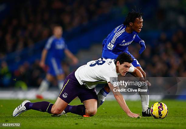 Juan Cuadrado of Chelsea clashes with Gareth Barry of Everton during the Barclays Premier League match between Chelsea and Everton at Stamford Bridge...