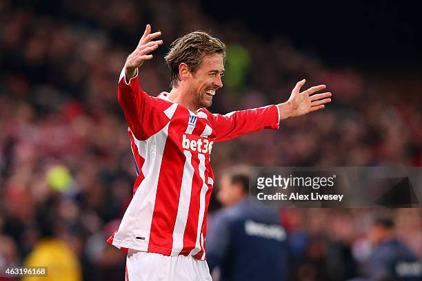 Peter Crouch of Stoke City celebrates after scoring his team's first goal during the Barclays Premier League match between Stoke City and Manchester...