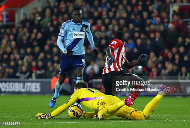 Adrian of West Ham dives on the ball outside of the area ahead of Sadio Mane of Southampton and subsequently receives a red card during the Barclays...
