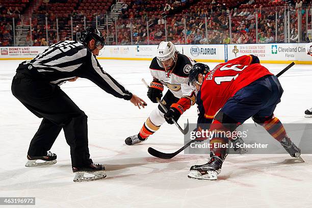 Linesmen Pierre Racicot drops the puck while Aleksander Barkov of the Florida Panthers and Nate Thompson of the Anaheim Ducks face off at the BB&T...