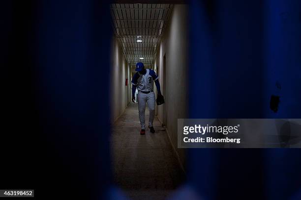 Member of the Industriales baseball team walks down a hallway to the field before a game at El Latinoamericano stadium in Havana, Cuba, on Thursday,...