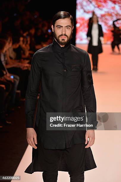 Model walks the runway at the Umasan show during Mercedes-Benz Fashion Week Autumn/Winter 2014/15 at Brandenburg Gate on January 17, 2014 in Berlin,...