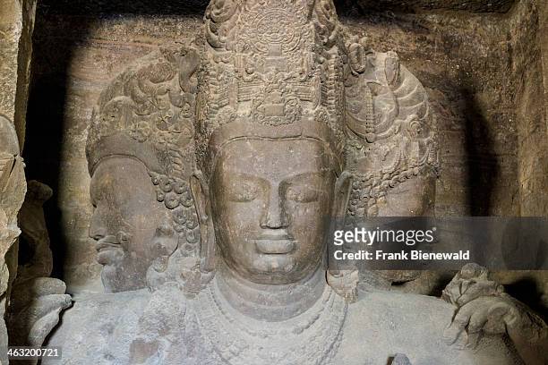 The 3 faces of Shiva inside the main cave on Elephanta Island, carved out of solid rock.