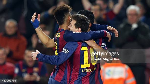 Lionel Messi of FC Barcelona celebrates with his team-mates Neymar and Luis Suarez as he scored the first goal during the Copa del Rey match between...