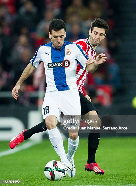 Juan Fuentes of RCD Espanyol duels for the ball with Markel Susaeta of Athletic Club during the Copa del Rey Semi-Final first leg match between...