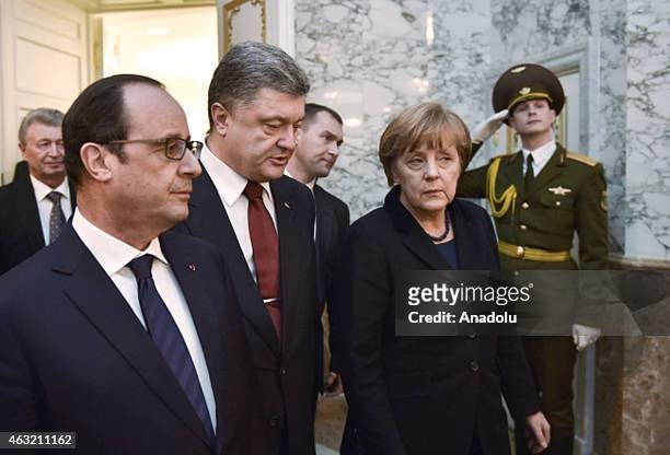Ukrainian President Petro Poroshenko , German Chancellor Angela Merkel and French President Francois Hollande attend the peace talks over the...