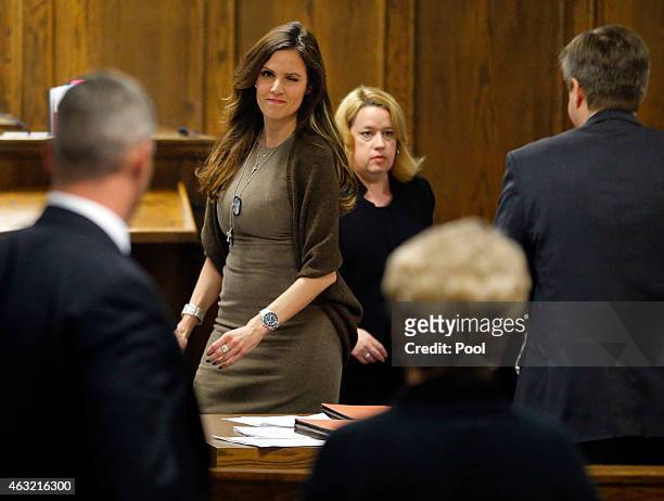 Taya Kyle, wife of former Navy SEAL Chris Kyle gives a wink to Judy Littlefield, mother of Chad Littlefield, during the capital murder trial of...