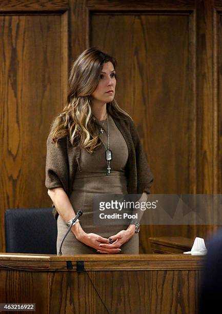 Wearing military dog tags and a cross around her neck, Taya Kyle, wife of former Navy SEAL Chris Kyle stands to wait for the jurors to enter the...
