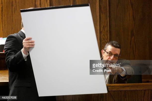 Rough Creek Lodge and Resort manager Frank Alvarez points to a map held by Erath County District Attorney Alan Nash during the capital murder trial...