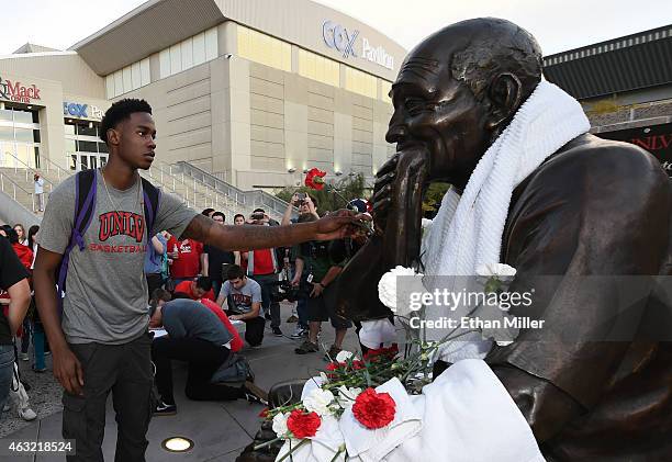 Current UNLV Rebels forward Dwayne Morgan puts a carnation on a statue of Jerry Tarkanian outside the Thomas & Mack Center at UNLV during a gathering...