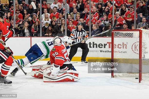 Zack Kassian of the Vancouver Canucks scores on goalie Corey Crawford of the Chicago Blackhawks in the second period during the NHL game at the...