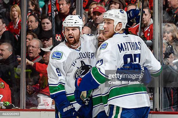 Zack Kassian of the Vancouver Canucks celebrates with Chris Higgins and Shawn Matthias after scoring against the Chicago Blackhawks in the second...