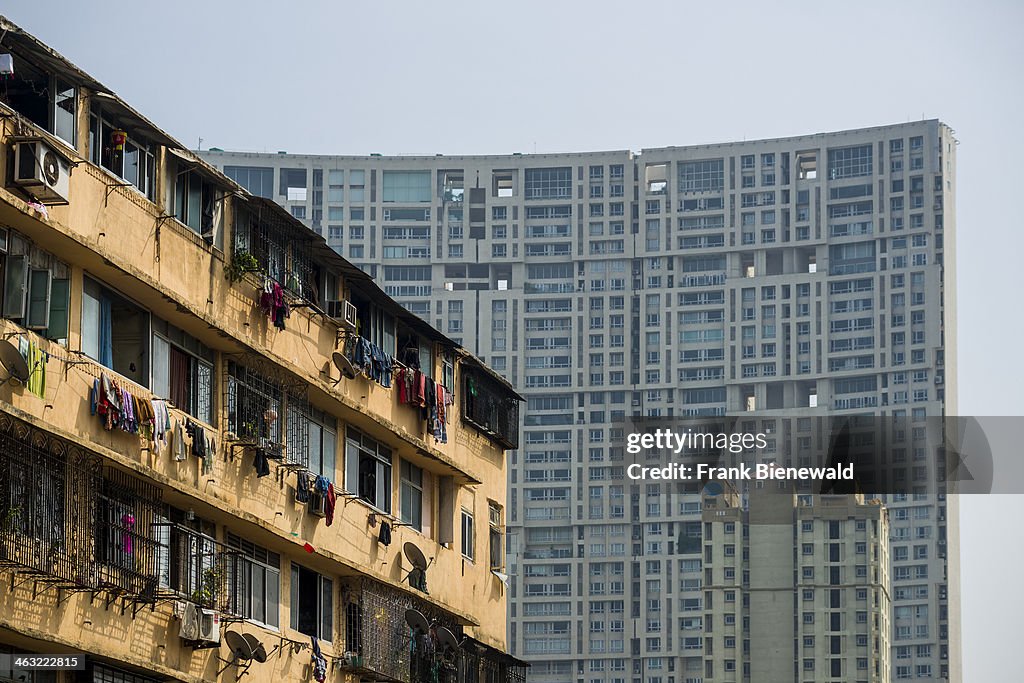 The facades of a big apartment buildings with the windows of...