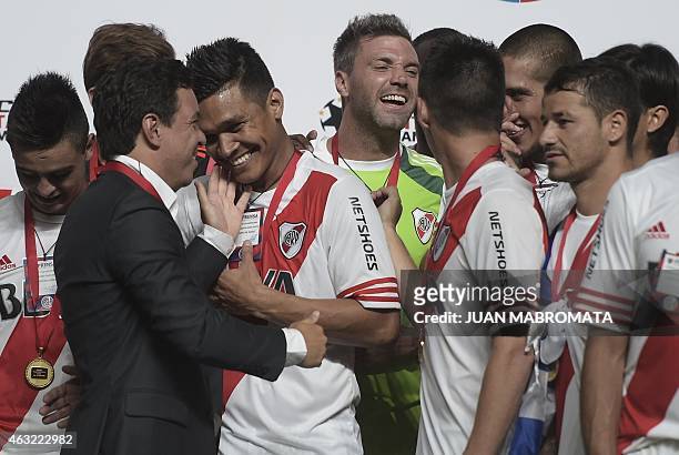 River Plate's coach Marcelo Gallardo jokes with forward Teofilo Gutierrez during the award ceremony of the Recopa Sudamericana 2015 after defeating...