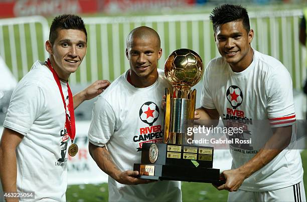 Matias Kranevitter, Carlos Sanchez and Teofilo Gutierrez of River Plate pose for a photo with the trophy after winning a second leg match between San...