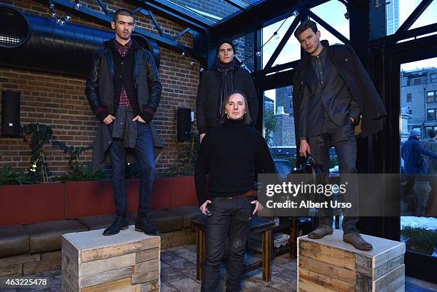 Fashion designer Stefan Miljanic poses with models at the Gilded Age presentation at Mercedes-Benz Fashion Week Fall 2015 on February 11, 2015 in New...