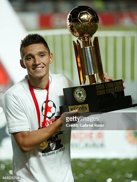 Matias Kranevitter of River Plate poses with the trophy after winning a second leg match between San Lorenzo and River Plate as part of Recopa...