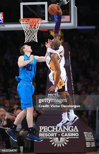 Kobe Bryant of the Los Angeles Lakers goes up for the slam dunk against Cody Zeller of the Charlotte Hornets during the NBA game at Staples Center on...