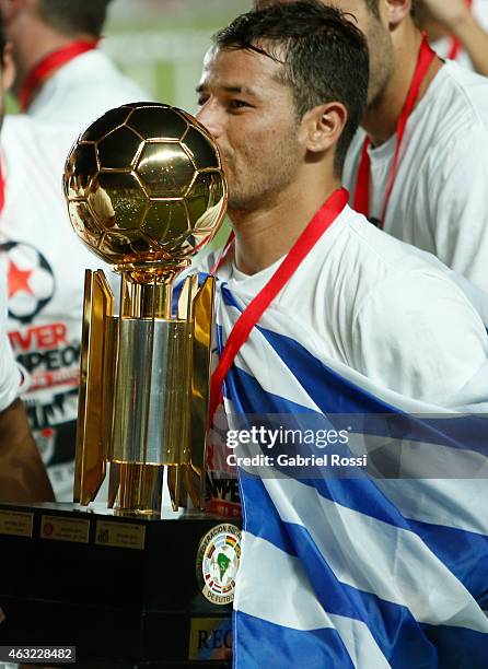 Rodrigo Mora of River Plate kisses the trophy after winning a second leg match between San Lorenzo and River Plate as part of Recopa Sudamericana at...