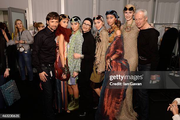 Designer Miranda Konstantinidou and stylist Andre Maertens pose with models backstage at the Miranda Konstantinidou show during Mercedes-Benz Fashion...