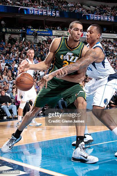 Rudy Gobert of the Utah Jazz drives against Greg Smith of the Dallas Mavericks on February 11, 2015 at the American Airlines Center in Dallas, Texas....