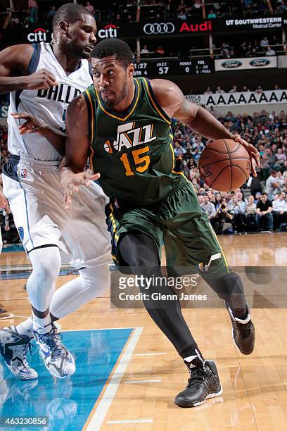 Derrick Favors of the Utah Jazz drives against Bernard James of the Dallas Mavericks on February 11, 2015 at the American Airlines Center in Dallas,...