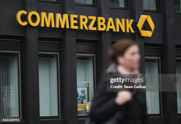 People walk past a branch of Commerzbank bank on January 17, 2014 in Berlin, Germany. Banks across Europe will be announcing their financial results...