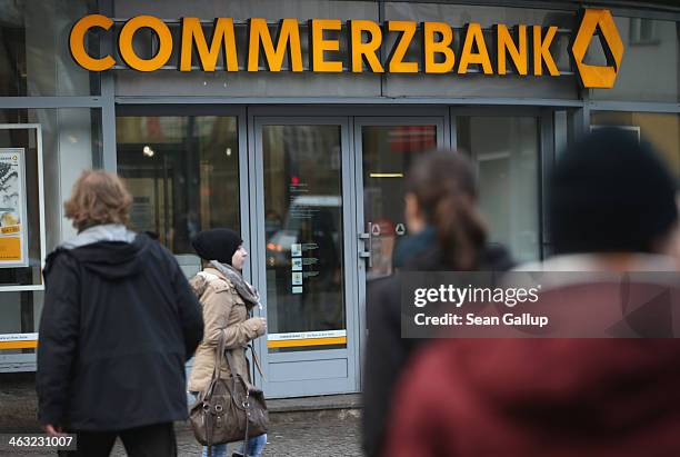 People walk past a branch of Commerzbank bank on January 17, 2014 in Berlin, Germany. Banks across Europe will be announcing their financial results...