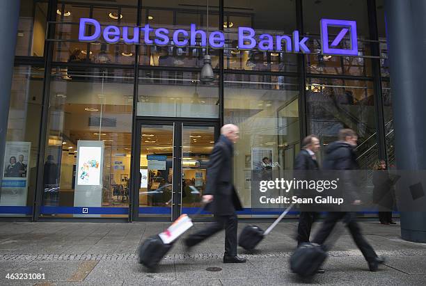 People walk past a branch of Deutsche Bank on January 17, 2014 in Berlin, Germany. Banks across Europe will be announcing their financial results for...