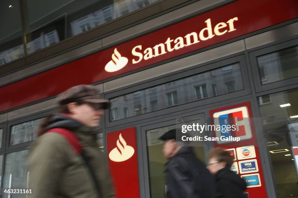 People walk past a branch Spanish bank Santander on January 17, 2014 in Berlin, Germany. Banks across Europe will be announcing their financial...