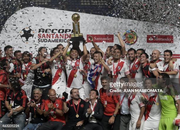 River Plate's forward Teofilo Gutierrez lifts the Recopa Sudamericana 2015 trophy surrounded by teammates after defeating San Lorenzo 1-0 in their...