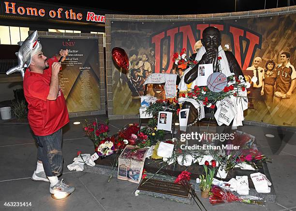 Josh Hamilton wears a shark hat as he takes photos of a statue of Jerry Tarkanian outside the Thomas & Mack Center at UNLV after a gathering of fans...