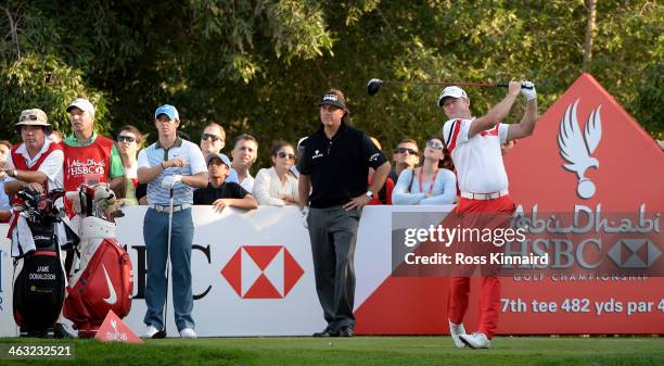 Jamie Donaldson of Wales is watched by Rory McIlroy of Northern Ireland and Phil Mickelson of the USA during the second round of the Abu Dhabi HSBC...