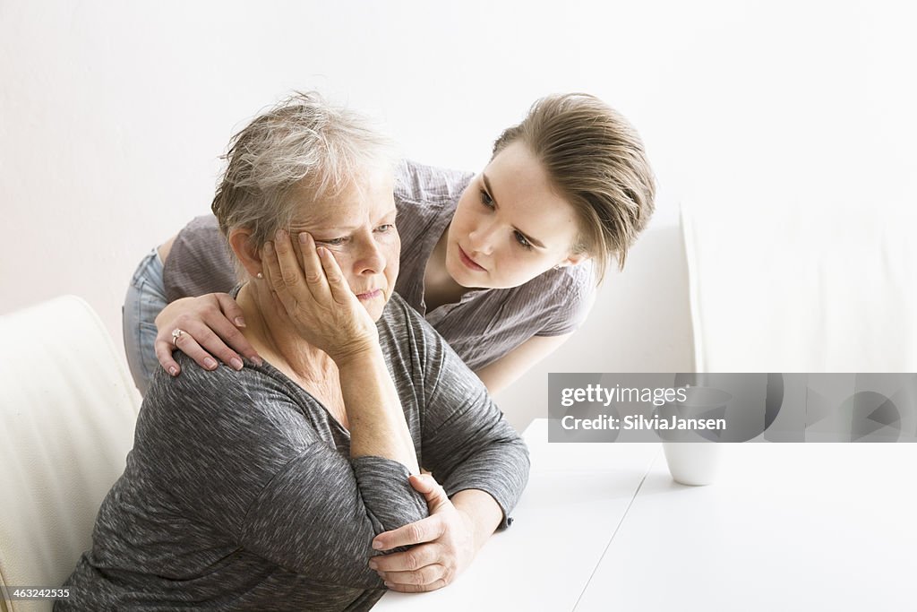 Young woman taking care of senior adult