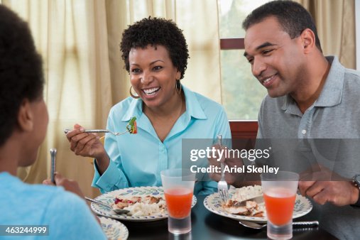 Black Family Eating Dinner Together High-Res Stock Photo - Getty Images