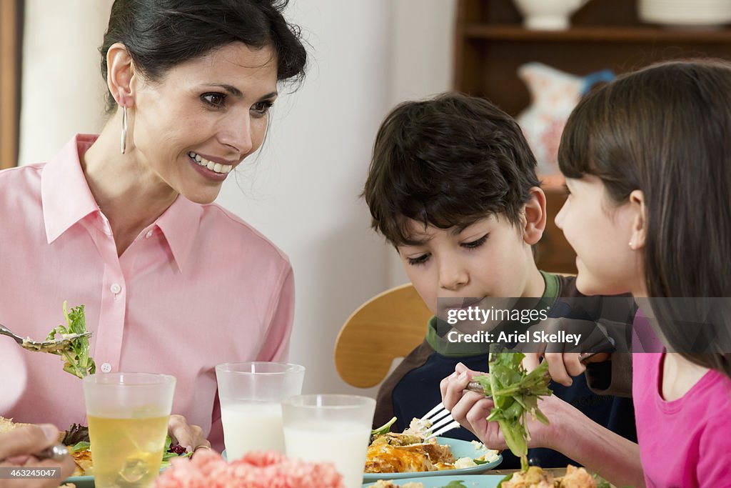 Hispanic family eating dinner together