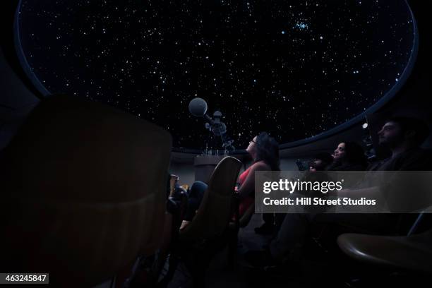 students watching constellations in planetarium - osservatorio foto e immagini stock