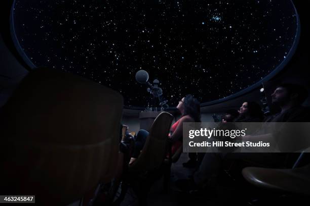students watching constellations in planetarium - observatorium stockfoto's en -beelden