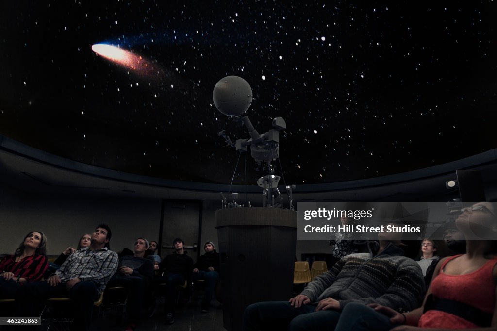 Students watching comet in planetarium