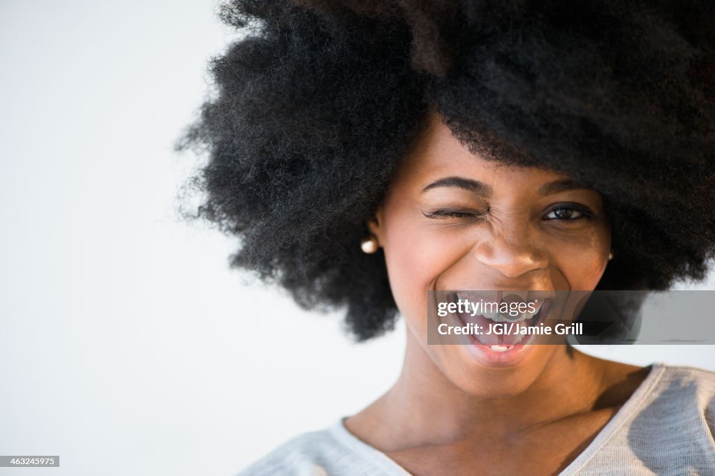 Mixed race woman winking